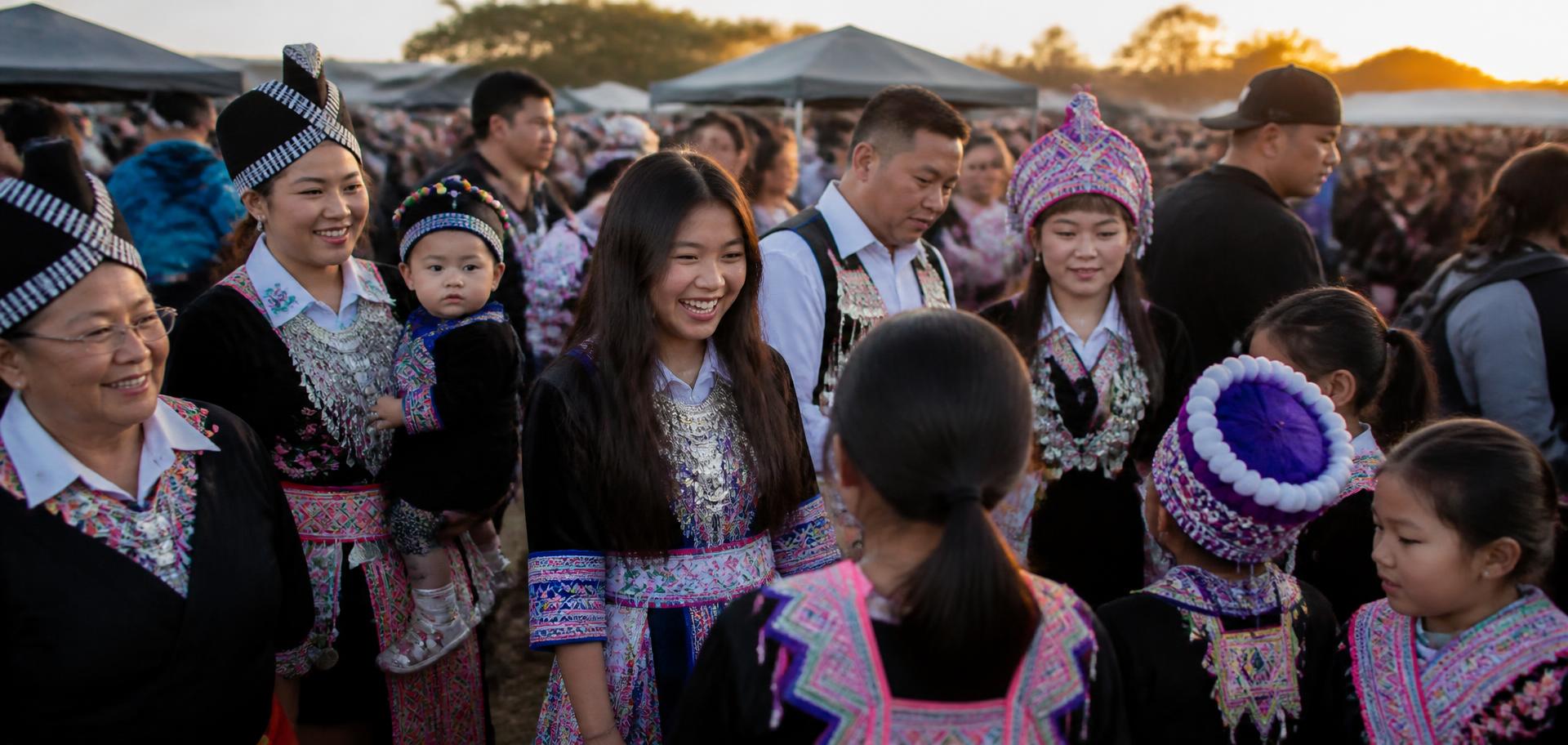 Hmong community members celebrating together at an outdoor gathering in Merced